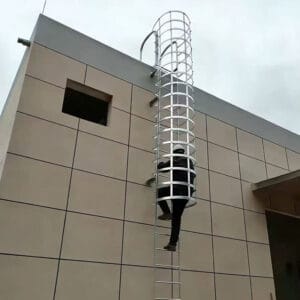 Galvanized vertical cage ladder for roof access and industrial buildings